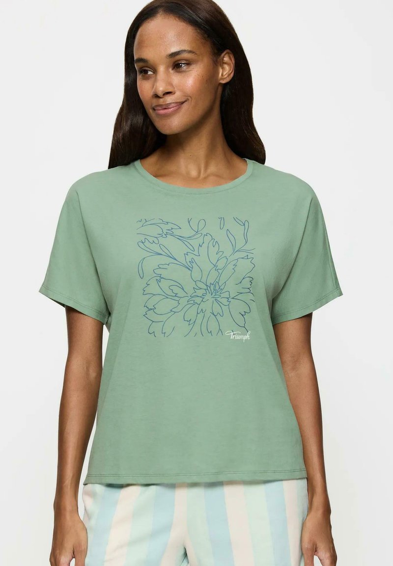 Zielona bawełniana koszulka z krótkim rękawem, z okrągłym dekoltem i luźnym fasonem, z przodu z rysunkiem kwiatowym w niebieskim kolorze.