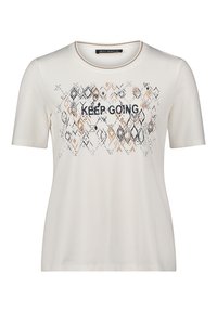T-shirt beige clair à manches courtes, col rond, avec le texte "CONTINUEZ". Présente un motif géométrique dans des nuances de noir et marron.