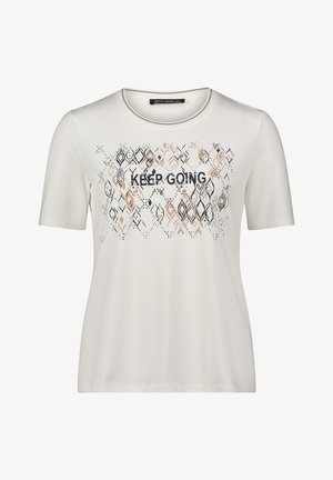 T-shirt beige clair à manches courtes, col rond, avec le texte "CONTINUEZ". Présente un motif géométrique dans des nuances de noir et marron.
