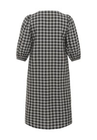 Robe à carreaux noire et blanche longueur genou avec manches ballons trois-quarts et encolure carrée, vue de dos sur fond blanc.