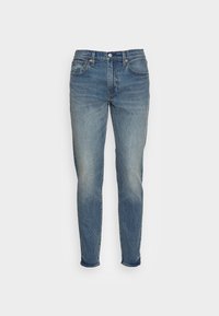 Ljusblå denimjeans med rak bendesign, med blekning och slitdetaljer. Klassisk femfickdesign med kopparnitar.