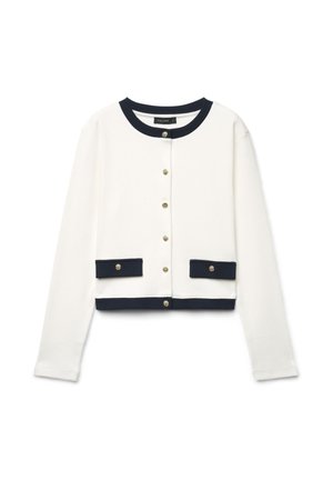 Weißes, langärmeliges, kurzes Cardigan mit schwarzem Besatz an Kragen, Saum und Taschenklappen, mit goldenen Knöpfen vorne und an den Taschen.