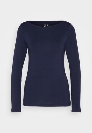Maglietta a maniche lunghe blu navy con scollo rotondo, realizzata in tessuto liscio ed elastico. Presenta un design aderente e polsini a coste. Logo del marchio sullo scollo.