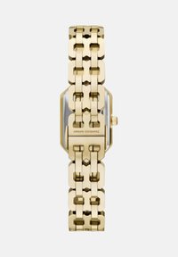 Ura s kovinskim ohišjem v zlati barvi z ovalno obliko in povezanim pasom. Ima prosojno ploščico ter vgravirano blagovno znamko na sponki.