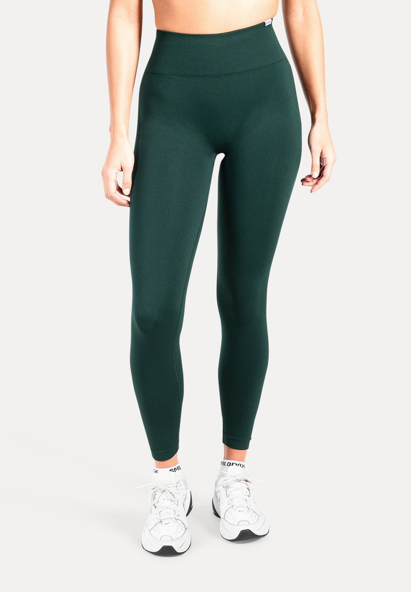 Donkergroene leggings met hoge taille, gemaakt van een rekbaar materiaal, met een gladde textuur en een nauwsluitend ontwerp.