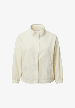 Veste en polaire couleur crème avec un col montant, des boutons-pression, des poches latérales et des poignets élastiqués. Texture douce avec une coupe décontractée.