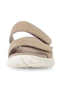 Beige suede sandals with two adjustable straps, a cushioned insole, and a white textured sole. The design is open-toed.