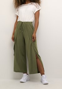 Cream Tygbyxor - dark green