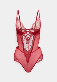 Κόκκινο κορμάκι από δαντέλα με διαφανές τούλι, σχέδιο με κουκκίδες, κυματιστά άκρα και λεπτομέρειες με λουριά που σταυρώνονται. Ρυθμιζόμενες λεπτές τιράντες.