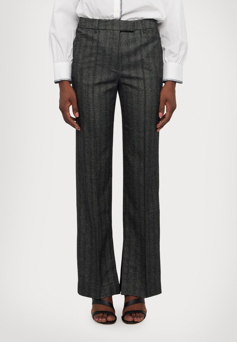 Gray pinstriped trousers in a woven fabric, featuring a flat front, wide-leg design, and a tailored fit. Paired with black sandals.