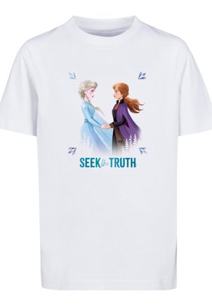 Dwie animowane kobiety trzymające się za ręce, stojące naprzeciwko siebie na białej koszulce z tekstem "Seek the Truth" poniżej nich.