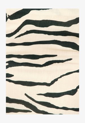 Tejido blanco con rayas negras irregulares similares a las de una cebra, formando un patrón animal abstracto y audaz.