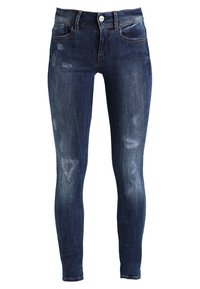 Tmavě modré skinny džíny vyrobené z denimu s oprýskanými záplatami, pěti kapsami a kovovým zapínáním v pase.