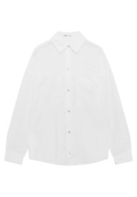 Chemise blanche boutonnée avec col, ornée de détails en œillets découpés, manches longues et une poche poitrine. Tissu en coton doux et texturé.