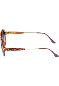Ochelari de soare din scoică cu accente de metal auriu, montură rotundă și brațe subțiri. Lentile întunecate și finisaj neted, lucios.