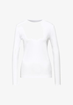 Camicia bianca a maniche lunghe con scollo tondo. Realizzata in tessuto leggero, presenta una texture liscia e dettagli a taglio vivo sulle maniche.