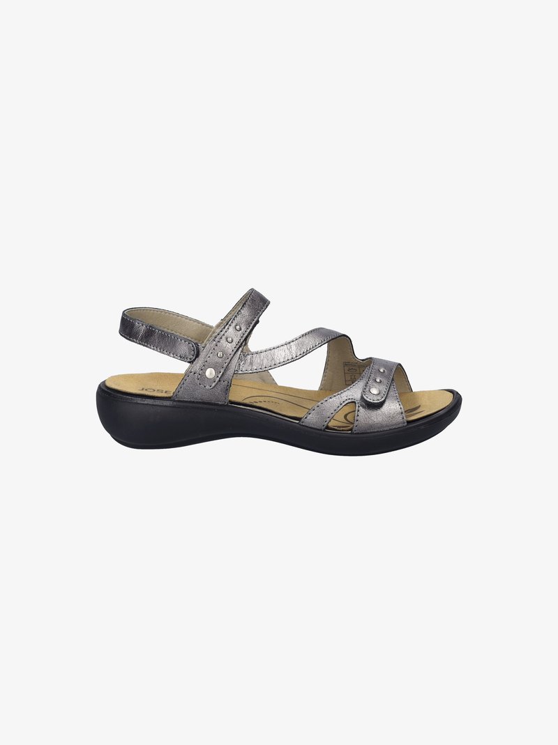 Metallic silver sandal with crisscross straps, decorative studs, padded footbed, and a black platform sole. Open-toe design.
