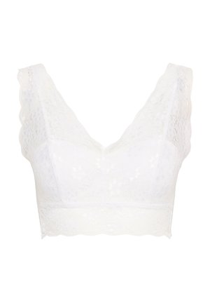 Bralette en dentelle blanche avec un décolleté en V plongeant, des bords festonnés et un motif floral sur un tissu doux et texturé.