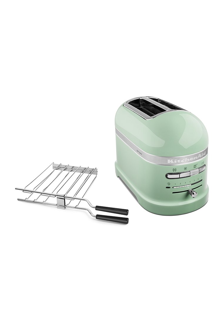 Grille-pain KitchenAid vert avec un design arrondi, une bande d'accent argentée et des boutons de contrôle, accompagné d'un grille-pain en chrome.