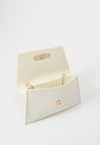 White faux leather clutch with a gold snap closure and chain strap. Interior features a smooth lining and minimalistic design.
