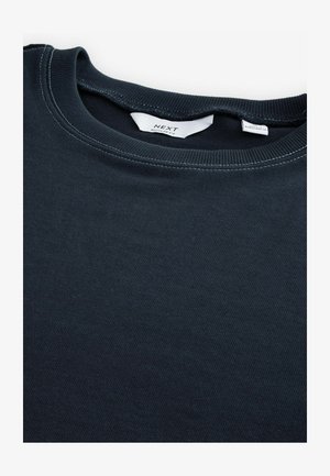 T-shirt à col rond bleu marine foncé en coton doux, avec une texture lisse et une coupe régulière, agrémenté de détails de couture contrastants.