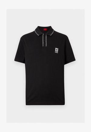 Schwarzes Polo-Shirt mit kurzen Ärmeln und weißen Ziernähten an Kragen und Leiste, mit kleinem weißem Blumenlogo und Schriftzug „HUGO“ auf der Brust.