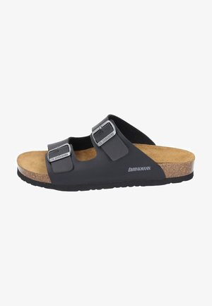 Black slide sandal featuring two adjustable straps with silver buckles, a cork footbed, and a textured rubber sole.