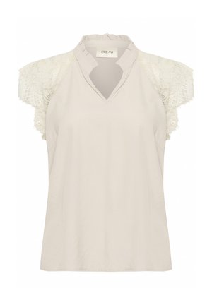 Jasno beżowa bluzka z dekoltem w serek, z krótkimi rękawami z teksturowanej koronką i falbanowym kołnierzem. Gładka faktura materiału, swobodny fason.