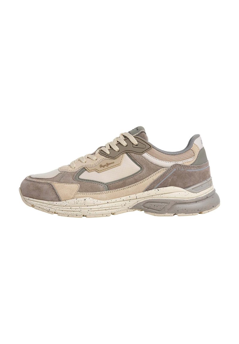 Sneaker med en blanding av beige og grå semsket skinn og mesh, med en tykk såle med flekker og beige snørelukking. Buede designelementer gjennom hele.