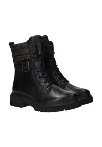Bottines en cuir noir avec un col en tissu texturé présentant un motif géométrique, des accessoires en métal et une épaisse semelle en caoutchouc.