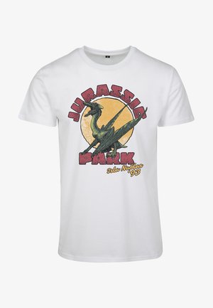 Valkoinen puuvillapaita, jossa on vihreä dinosauruksen grafiikka ja punaiset sekä keltaiset "Jurassic Park" -tekstit sekä päivämäärä "Isla Nublar '93."