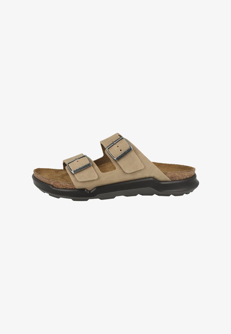 Tan ruskinds slide sandal med justerbare dobbelte stropper, metalspænder, korkfodbed og sort gummisål.