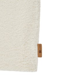Soft, white textured fabric with a fluffy finish; includes a small brown leather tag with logo on the edge.