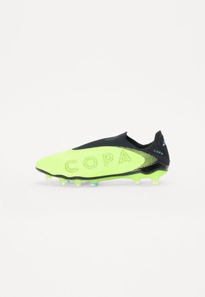 Lime green soccer cleat with a black sock-like collar. Features "COPA" embossed on the side and a textured surface with studded outsole.