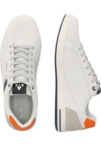 White leather sneakers with a textured finish, featuring grey laces, a navy accent on the sole, and an orange heel detail.