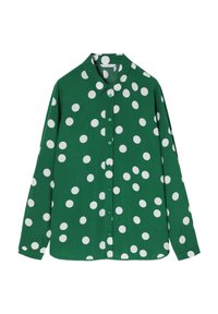 Chemise verte à manches longues avec des pois blancs et un col pointu.