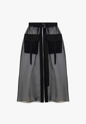Black sheer skirt with a gathered waistband, featuring two large front pockets, a waist tie, and a circular metal accent.