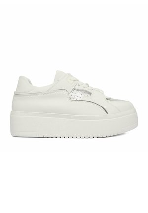 Hvid platformsneakers med tyk sål, snørelukning foran og perforerede sølvsidepaneler, vist i profil på hvid baggrund.