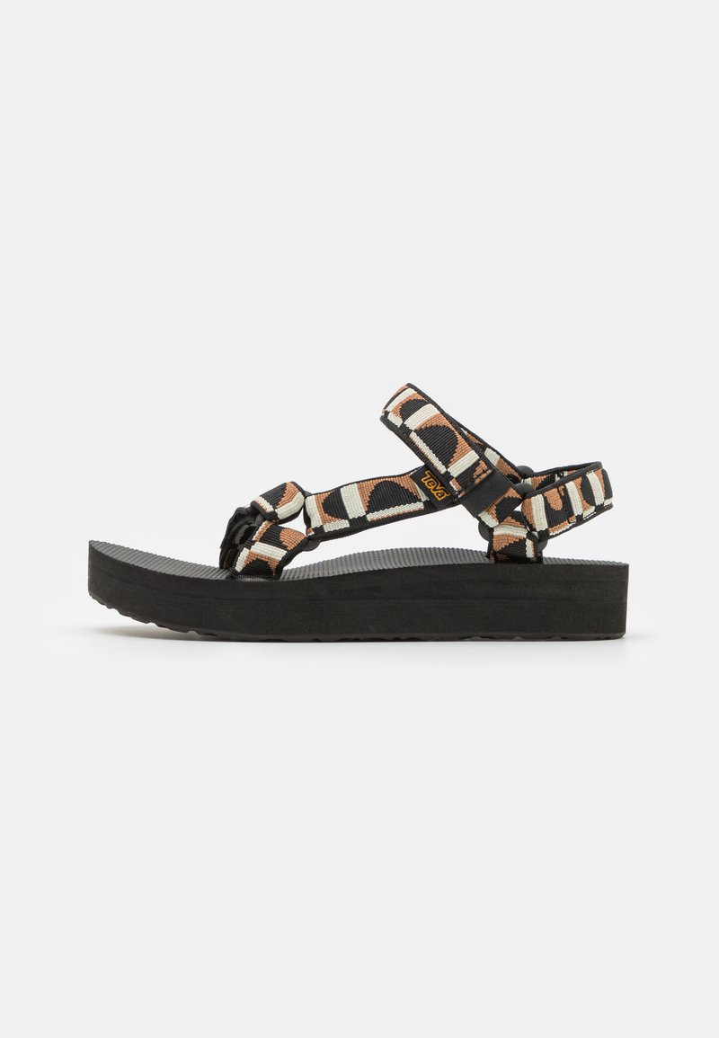 Black platform sandals with multicolored geometric straps, featuring adjustable ankle and toe straps, textured rubber sole.