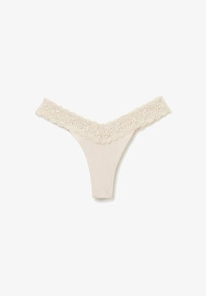 Beige tanga underkläder med spetsdetaljer som har blommönster vid midjan, slät tyg och en V-formad frontdesign.