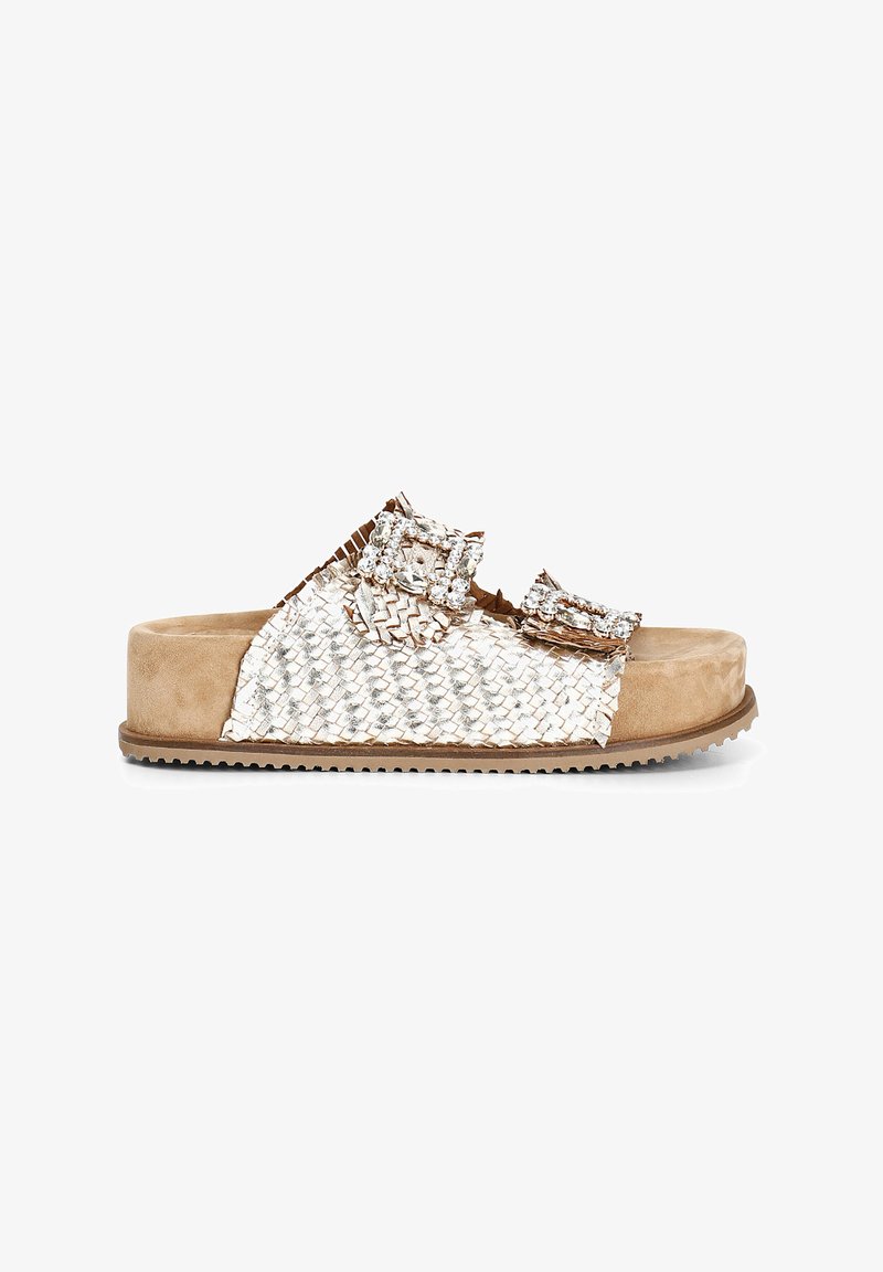 Woven metallic silver and beige slip-on sandal featuring two adjustable buckles, a cushioned footbed, and a textured rubber sole.