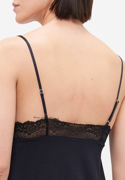 Black camisole featuring thin adjustable straps and a lace trim along the neckline, with a smooth, lightweight fabric and minimal detailing.