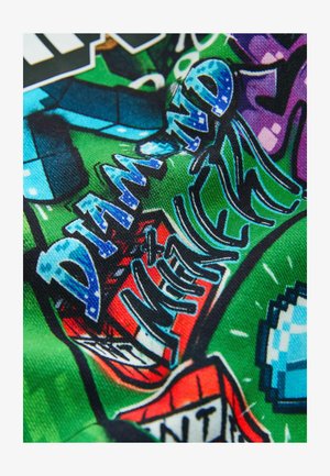 Krāsains auduma prints ar grafiti stila tekstu, kas lasāms "DIAMOND NEW YORK" zilā, melnā un baltā krāsā uz zaļas un sarkanās fona.