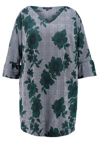 Zielona bluzka w kwiaty na wzorze w kratę, z dekoltem w serek i luźnym krojem. Posiada falbaniaste rękawy oraz lekką tkaninę.