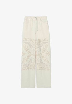 Jean écru à jambes larges, taille haute, avec une broderie florale symétrique subtile sur les jambes avant.