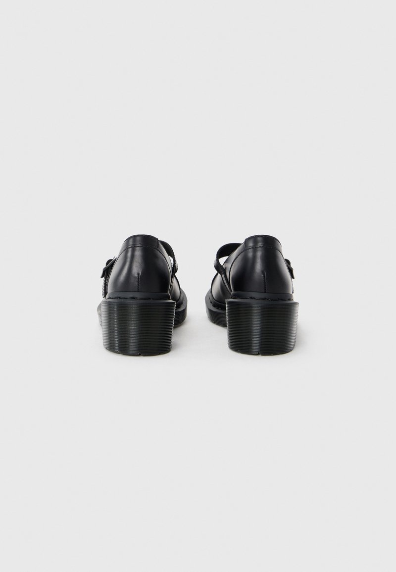 Zwarte leren schoenen met een ronde hak, voorzien van verstelbare bandjes en een gladde textuur. Minimalistisch ontwerp, met de nadruk op functionaliteit.