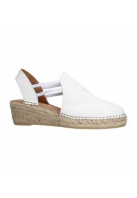 Espadrille compensé en cuir blanc avec un bout arrondi, des sangles élastiques et une semelle en jute. Présente des détails cousus le long du bord.