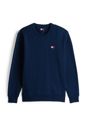 Sudadera azul marino hecha de mezcla de algodón con cuello y puños acanalados, que presenta un pequeño parche con el logo en el pecho. Mangas largas.