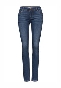 Tumman siniset skinny-farkut, jotka on valmistettu denimistä ja joissa on klassinen viiden taskun muotoilu, vyölenkit ja lievästi kulunut pinta.