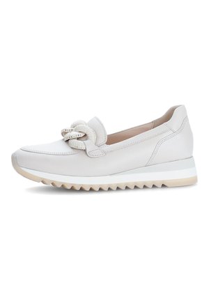 White leather slip-on shoe with a textured knot detail on the toe, featuring a contrasting rubber sole with a zigzag pattern.